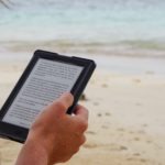 person holding black tablet computer during daytime