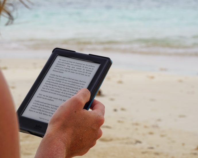 person holding black tablet computer during daytime