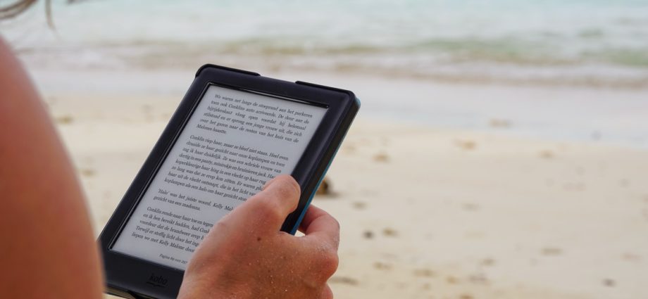 person holding black tablet computer during daytime