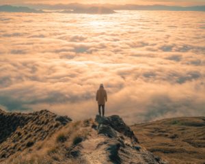 person standing on top of mountain