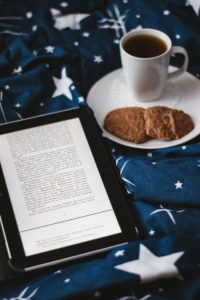 white ceramic mug beside brown cookies on white ceramic plate