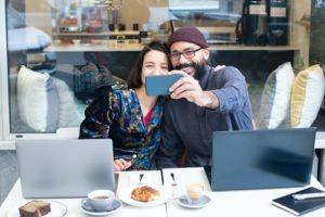 A Man and a Woman Taking Selfie Photo